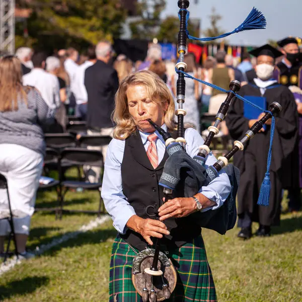 Hope Oaks playing the bagpipes for the graduating class.