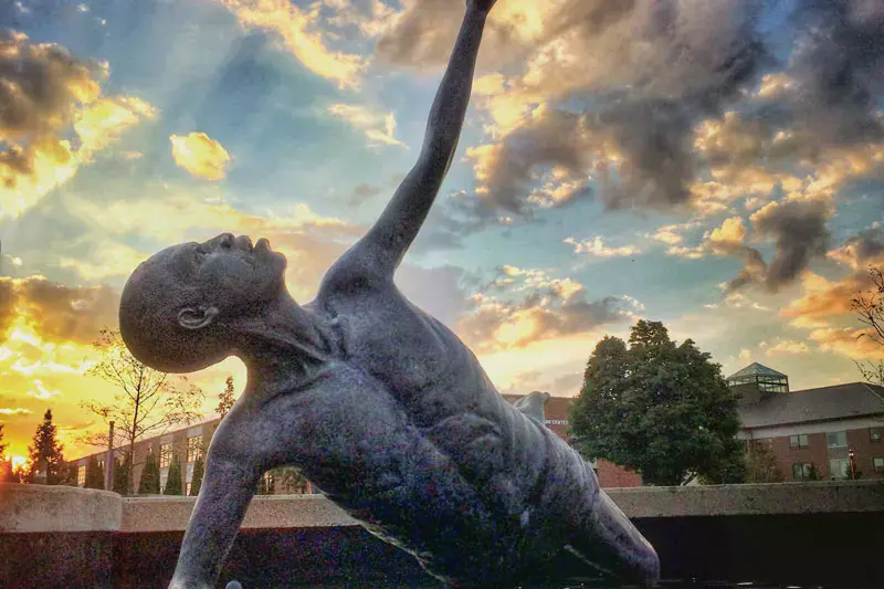 Sammy statue reaching to the heavens at sunset
