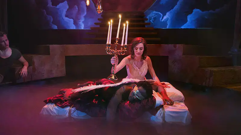 Lady holding a candelabra above a sleeping man in Metamorphoses