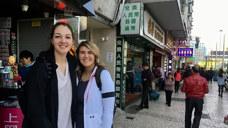 Two female students in a Chinese market