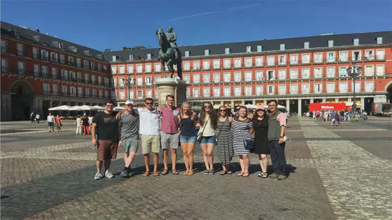 Students gathered for a photo in front of the Fillipe III statue in Madrid, Spain