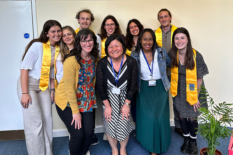 students gathered with golden stoles