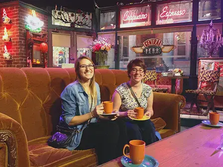 Two female students drinking coffee on the Friends Café set in Warner Bros Backlot