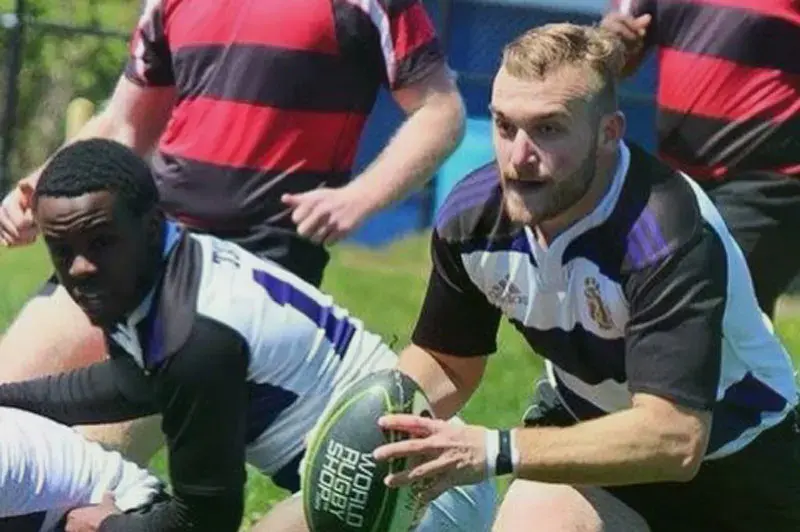 A Taylor Rugby player rushing the ball forward