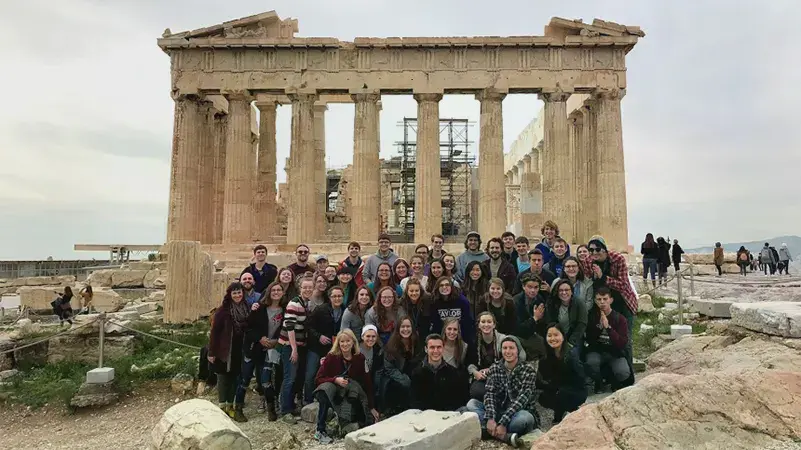 Group of Honors Guild students and professors in front of the Parthenon in Greece