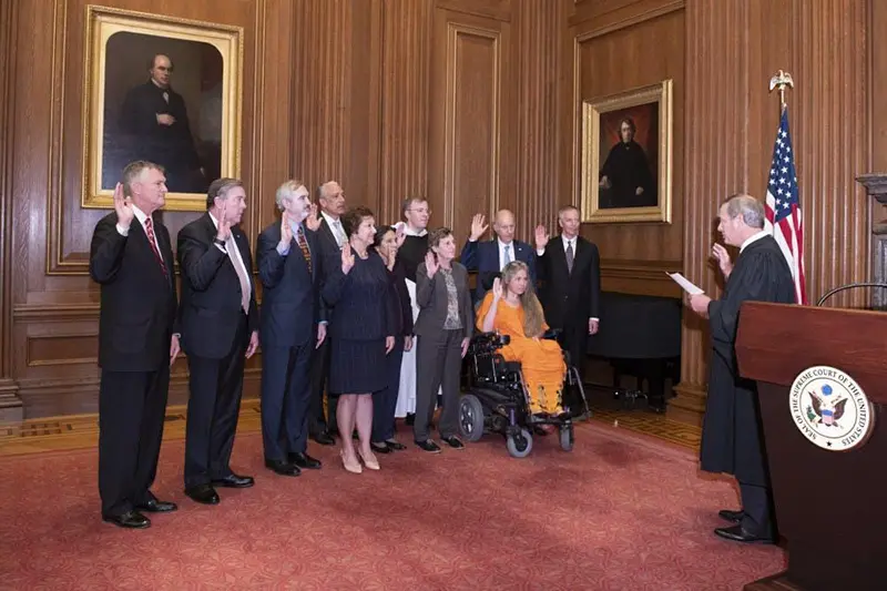 A group of people being sworn into office