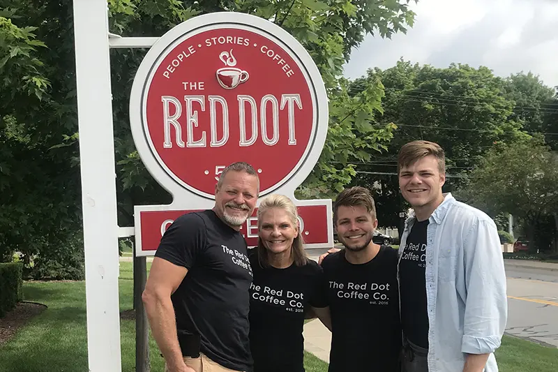 Ibach family in front of coffee shop sign