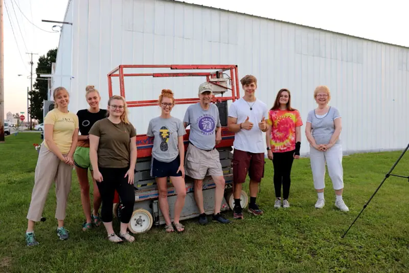 group of art students and professors in front of the mural site