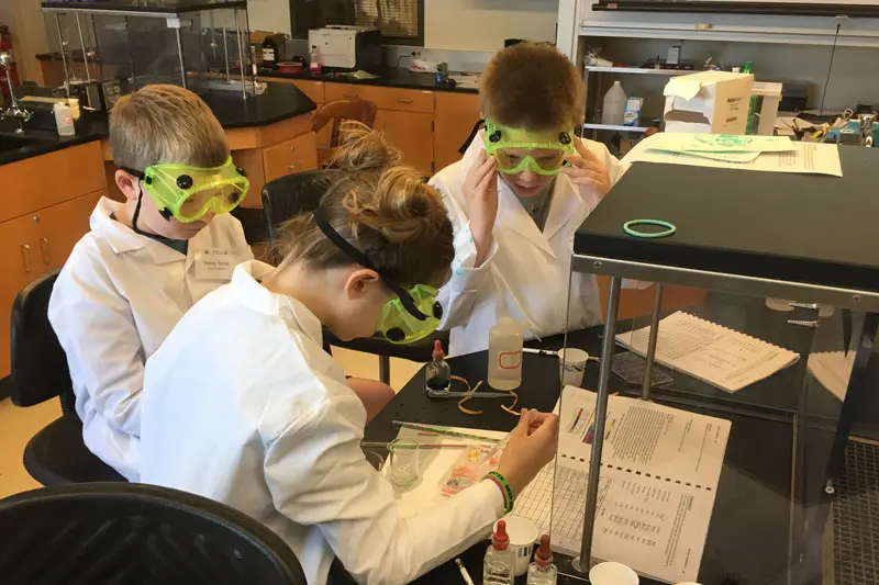 children working with chemistry equipment