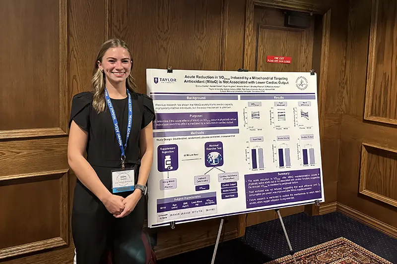 Emma standing next to poster presentation