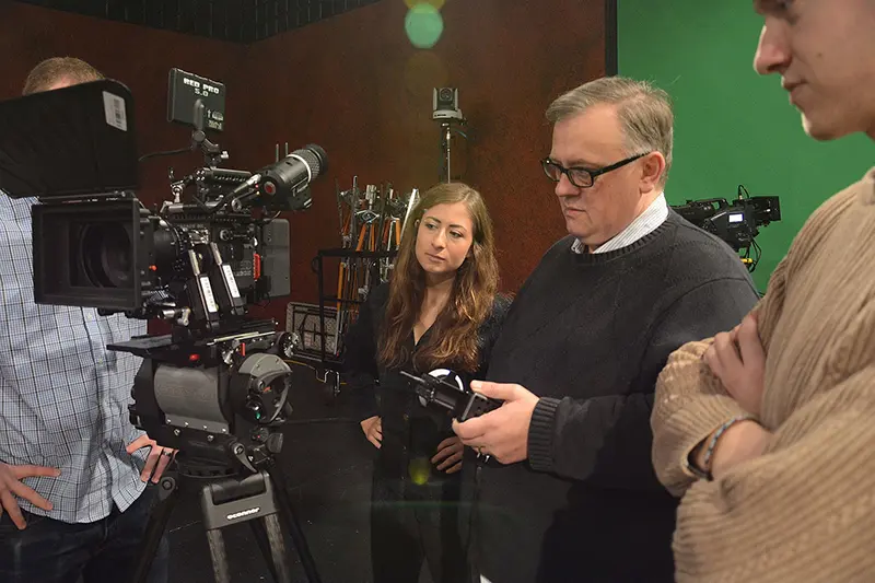 film professor demonstrates camera to film students