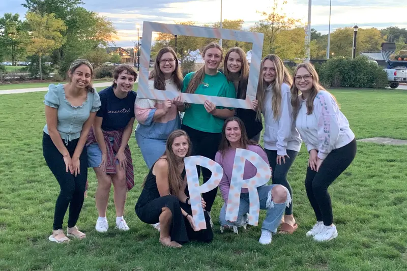 Group of Public Relations students on grassy area