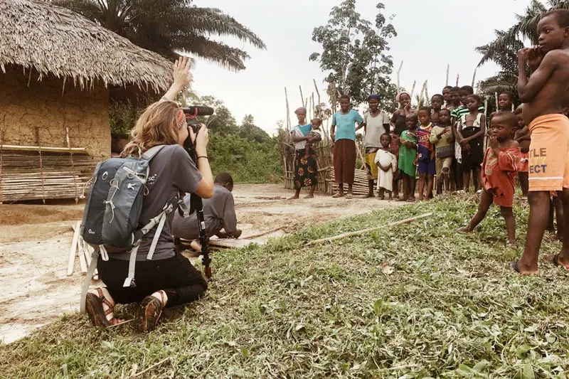 Olivia McCash taking a video of a group of people