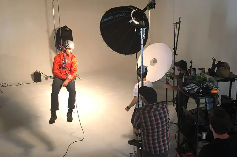 Student hanging from ceiling in a studio