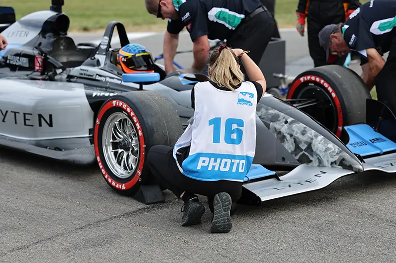 Hailey Hamilton taking photos of a racecar