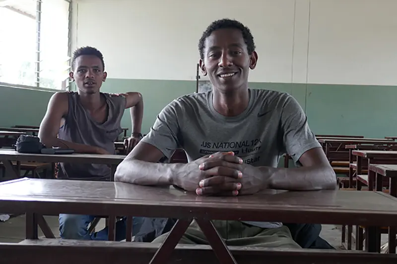 Gerber sitting at a desk in a classroom