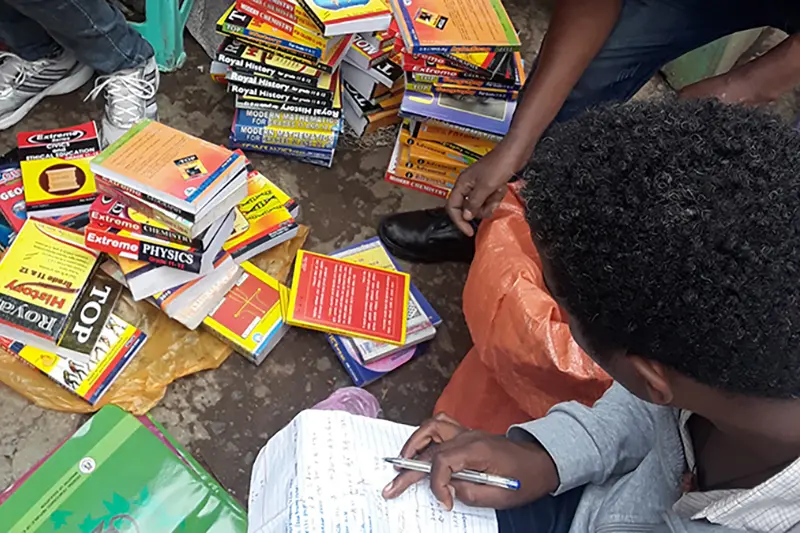 Gerber with a notepad and a stack of books