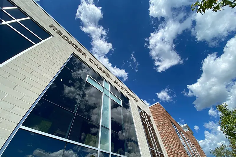 Rediger Chapel and Auditorium with blue sky and clouds