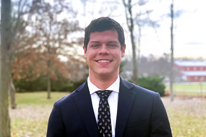 Craig Martin in front of wooded background