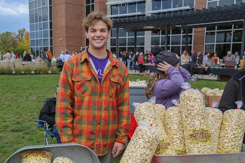 student vendor selling popcorn