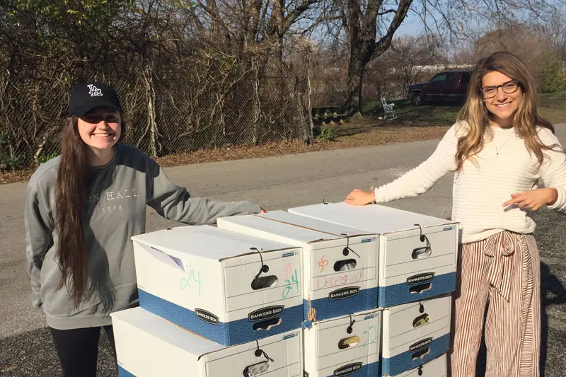 female students in front of boxes of used prescription drugs