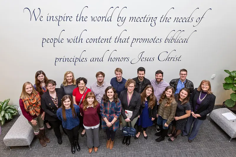 Professional Writing majors standing in front of a mural