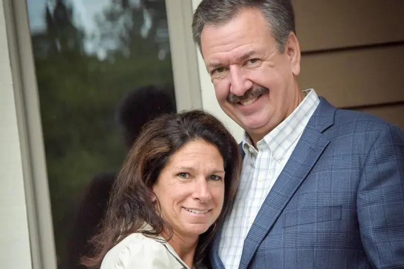 smiling couple outside home