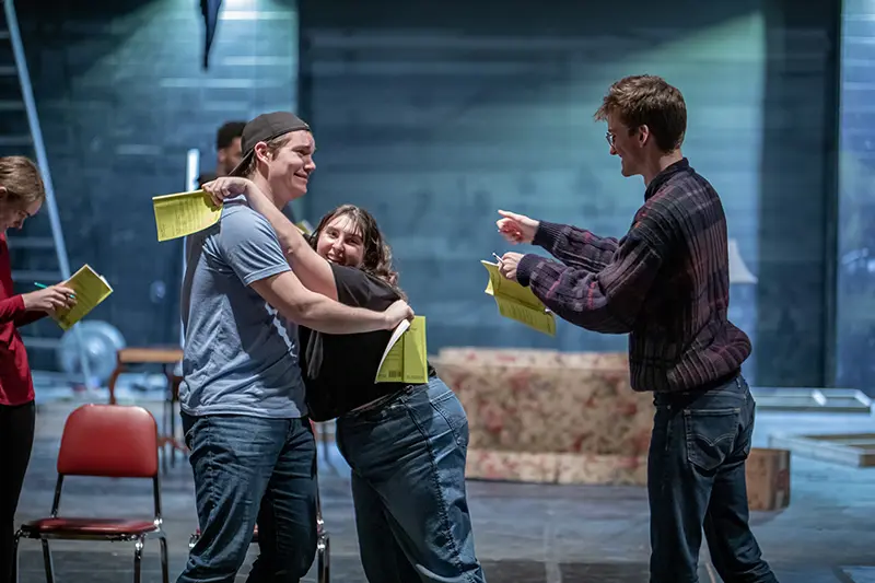 cast members of Noises off rehearse on stage