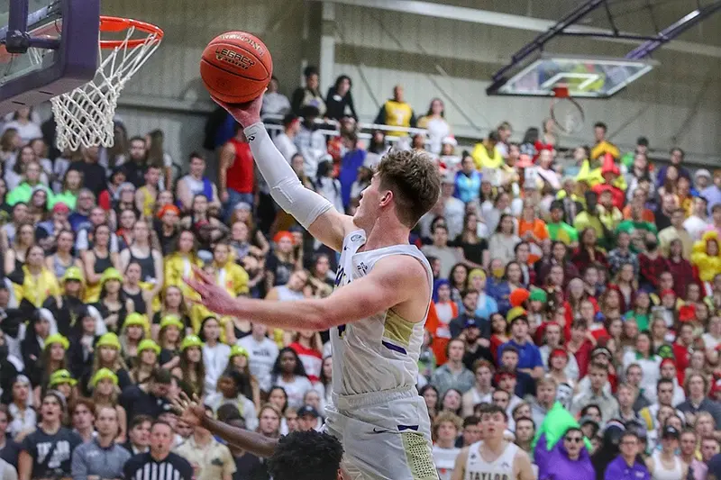 basketball player in front of costumed fans