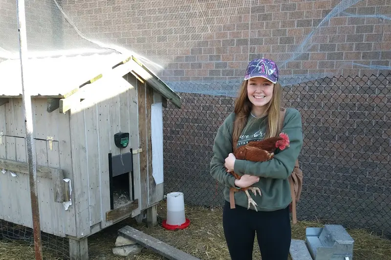 Student holding chicken